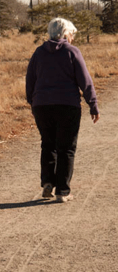 woman walking on a dusty road